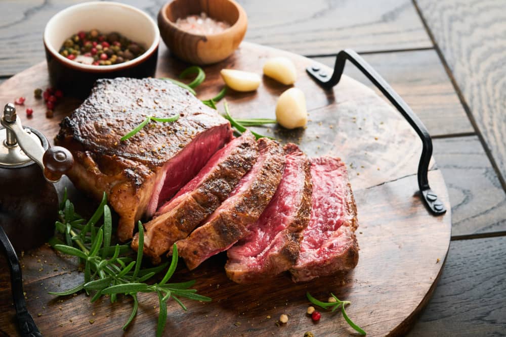 Slices of beef on wooden platter